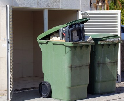 Staff member wearing PPE while handling segregated waste bags